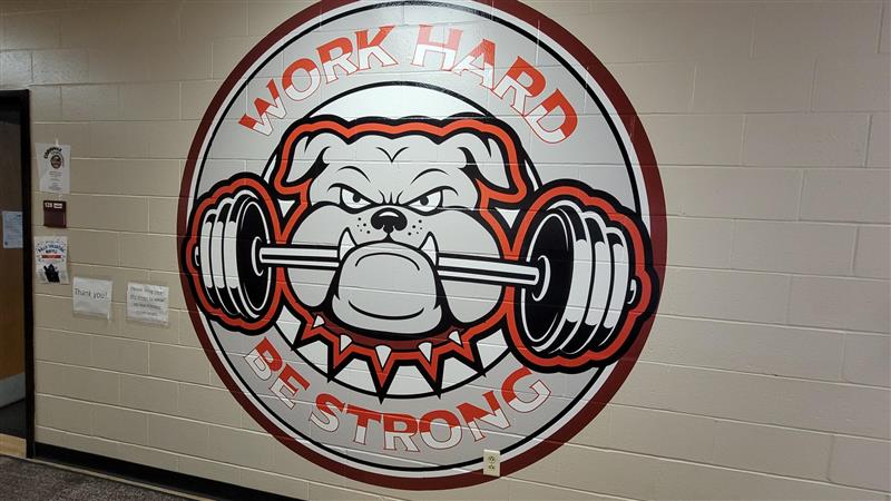 Graphic of Bulldog with a barbell in its teeth with the text Work Hard Be Strong