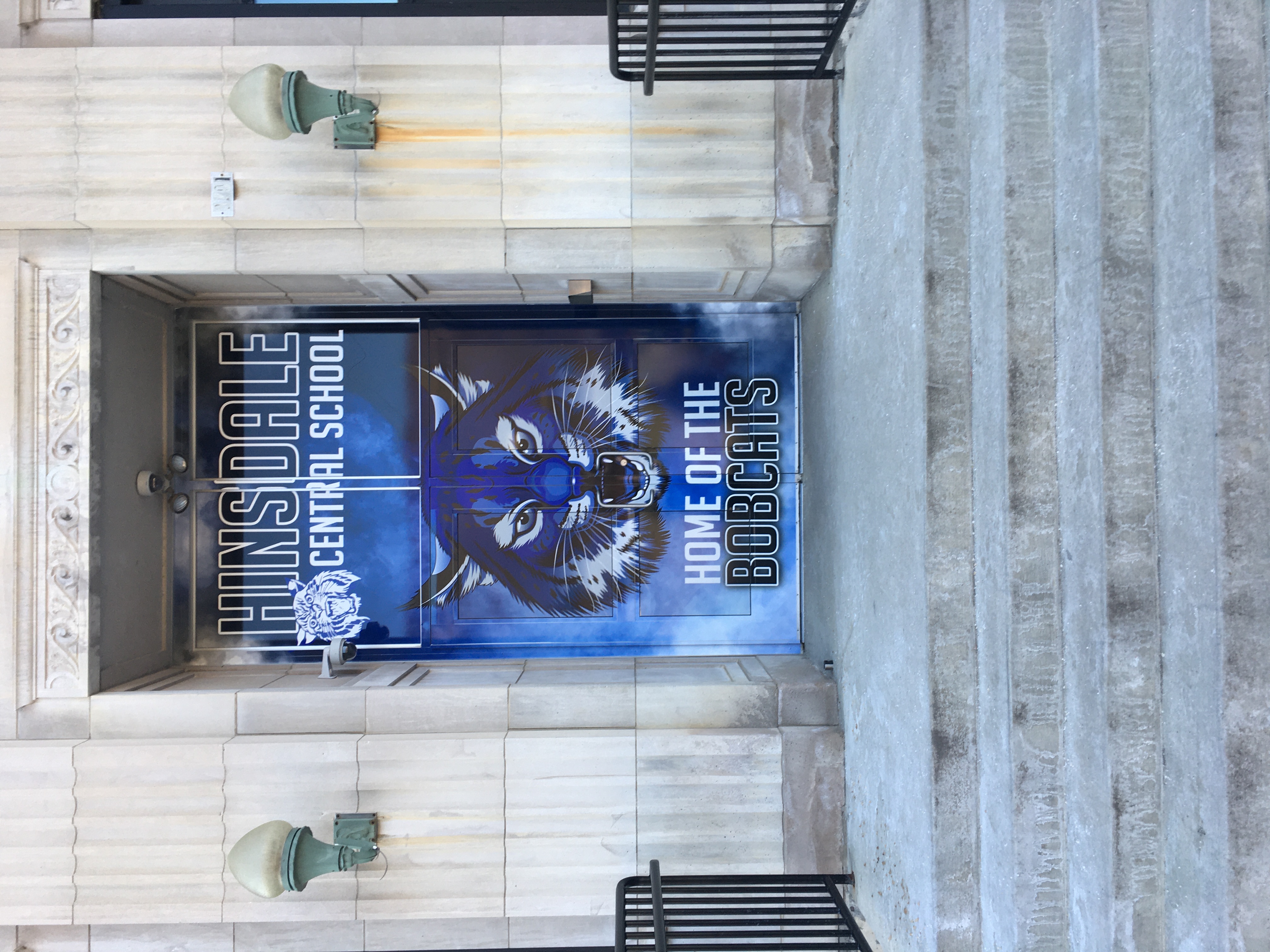 Large format door wrap designed for the entrance of HSD. Features school branding and mascot with the text "Home of the Bobcats"
