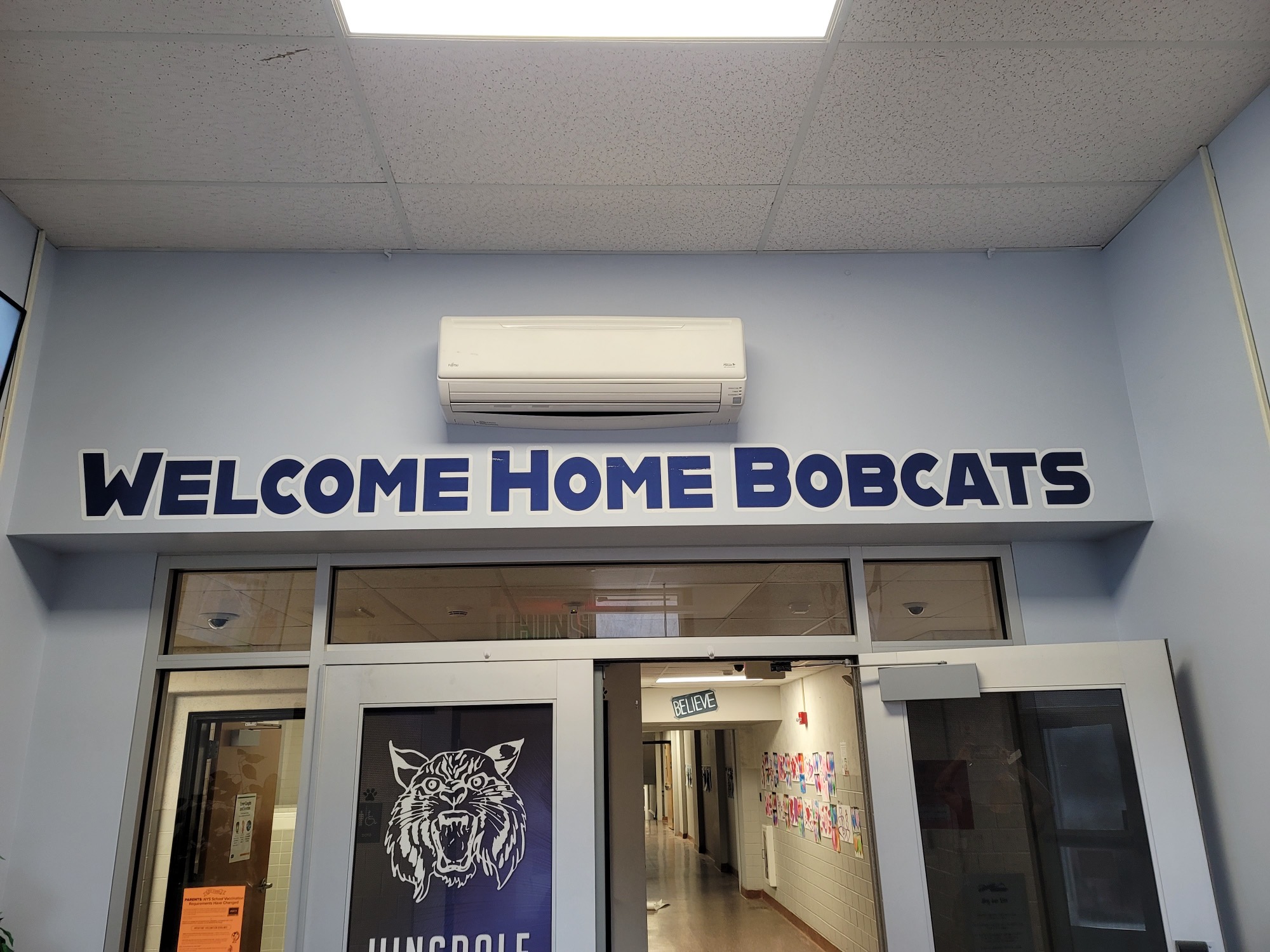 Large wall vinyl graphics that reads Welcome Home Bobcats in Blue.