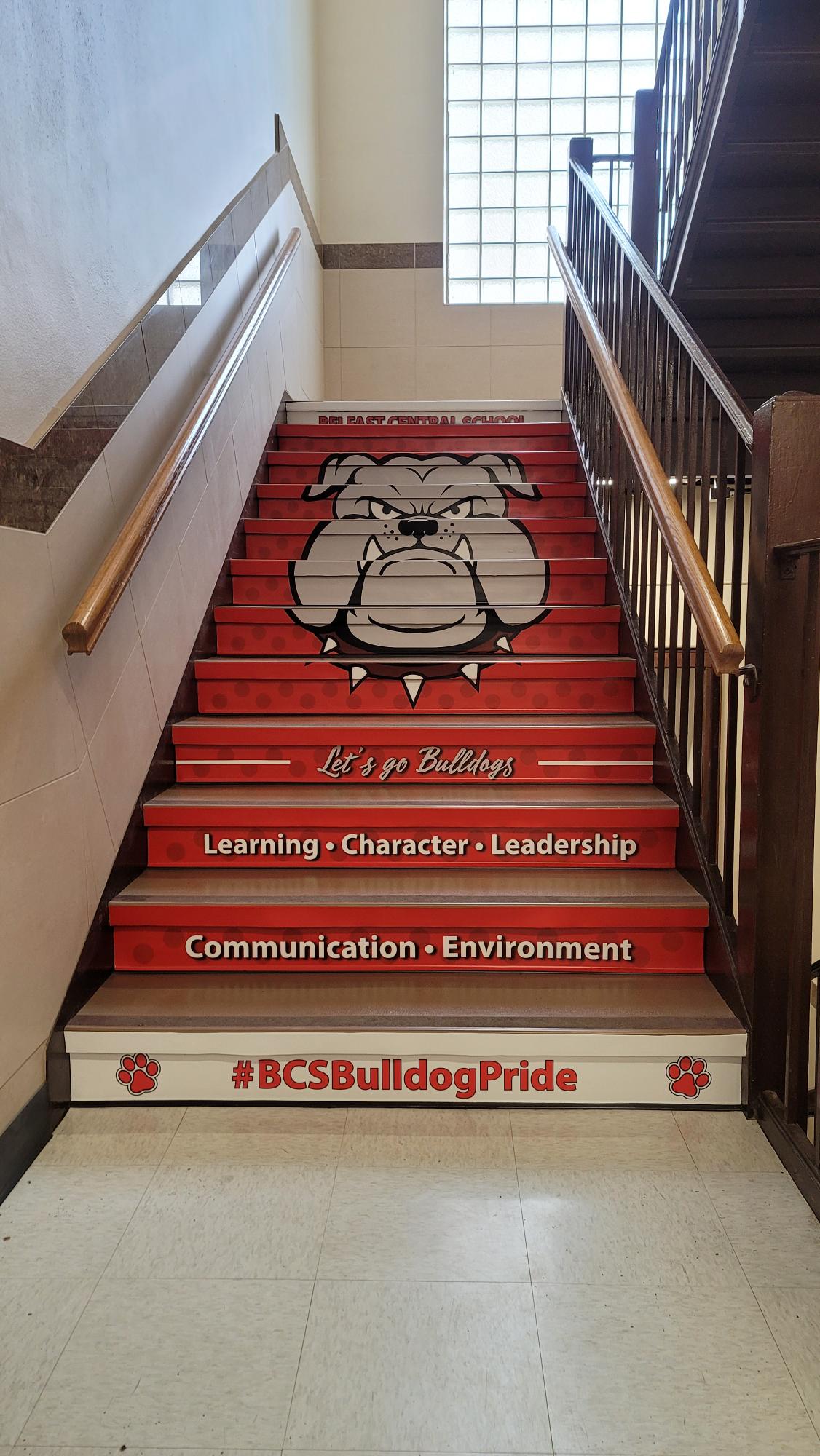 Large graphic installed on stairs featuring Belfast Central School Branding with motivational text.
